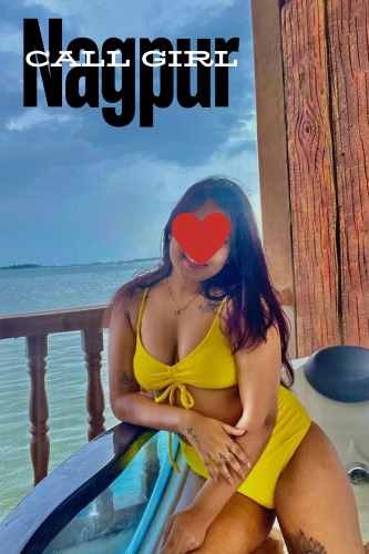 A girl is sitting in a boat inside the sea wearing a yellow color dress,